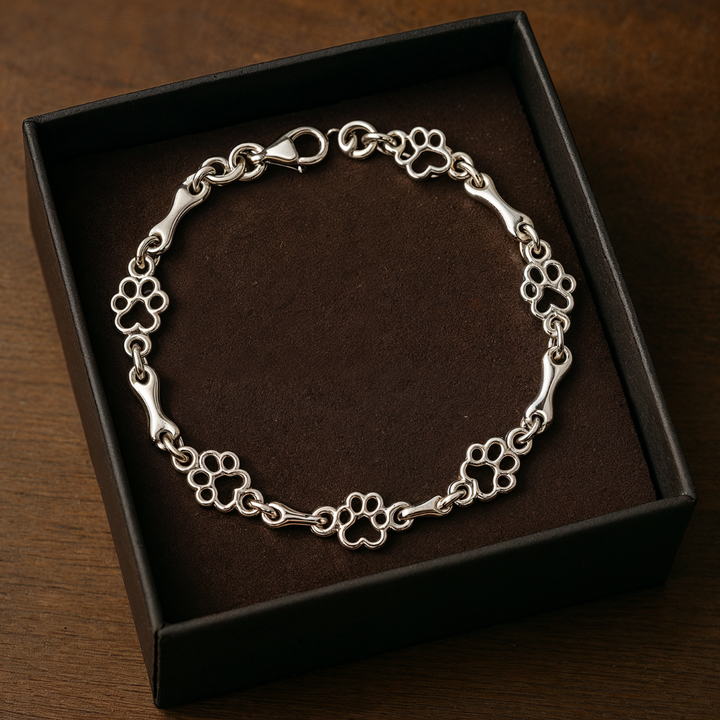 Silver bracelet with dog paw prints and a bone
