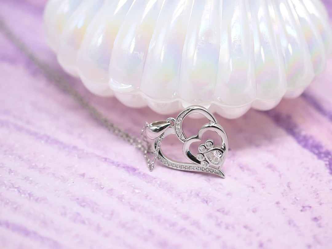 Silver necklace with a footprint and heart, set with zirconia.