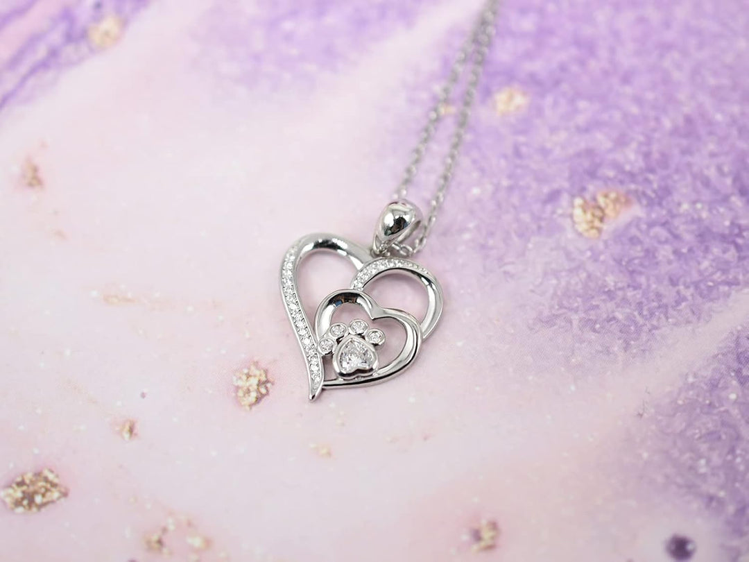 Silver necklace with a footprint and heart, set with zirconia.