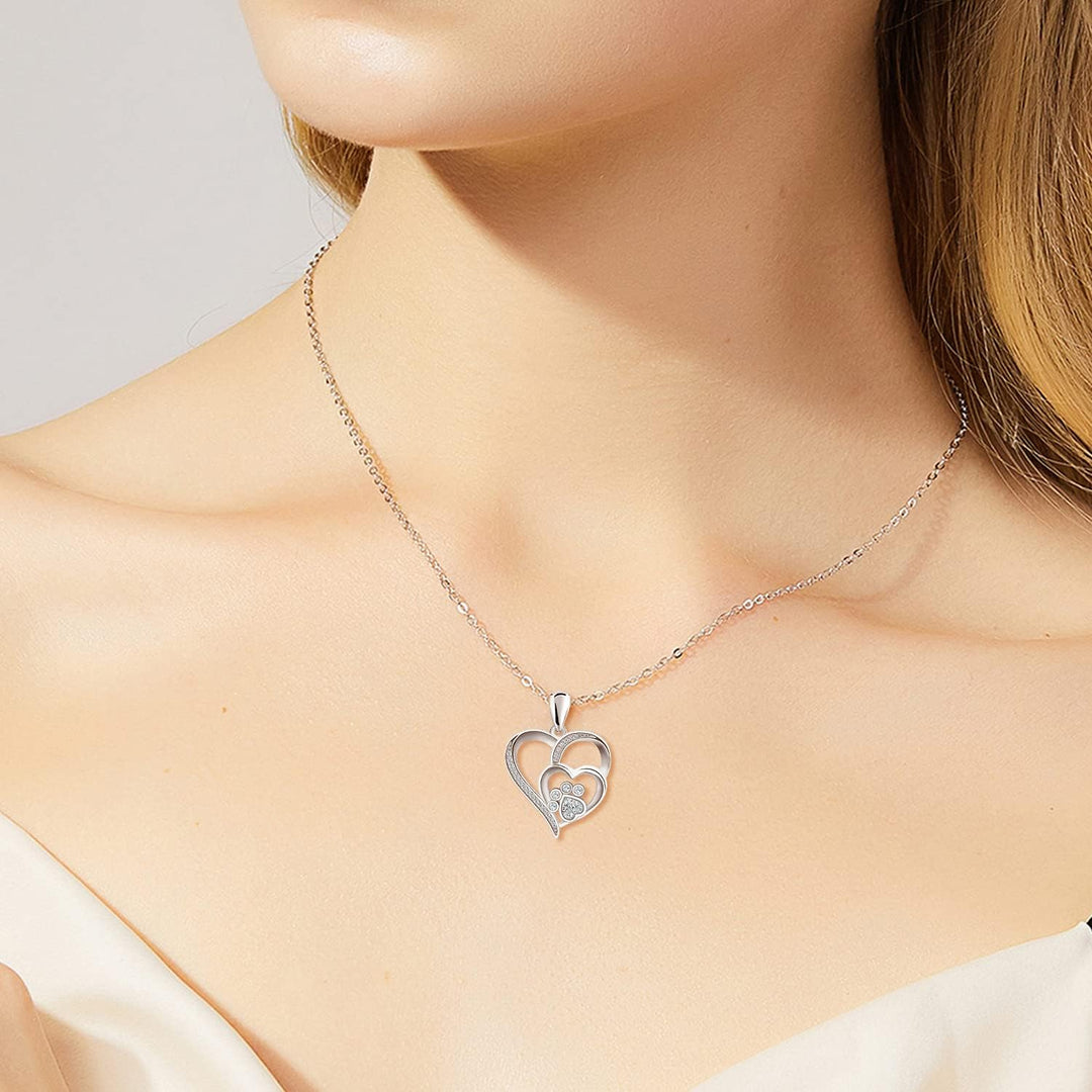 Silver necklace with a footprint and heart, set with zirconia.