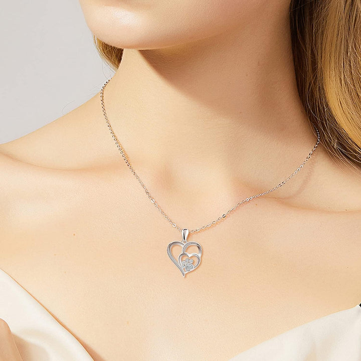 Silver necklace with a footprint and heart, set with zirconia.
