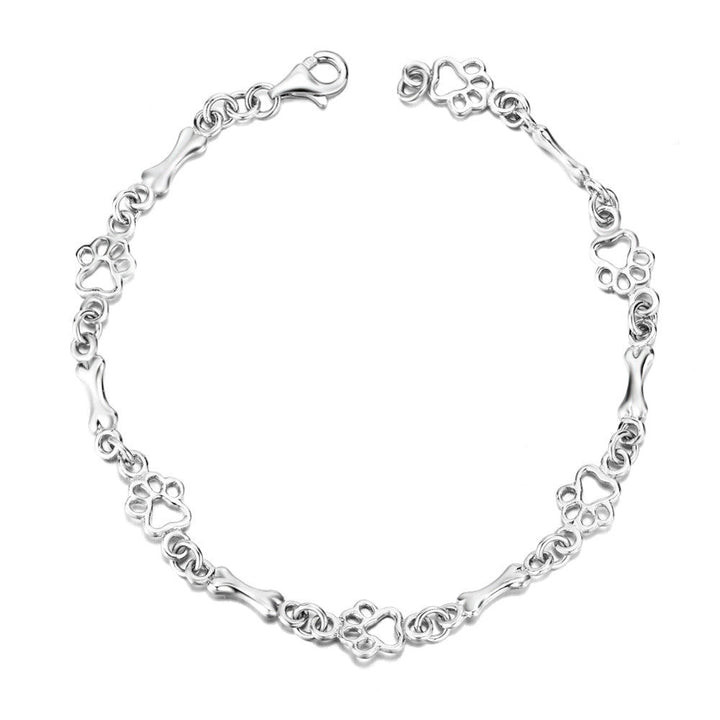 Silver bracelet with dog paw prints and a bone