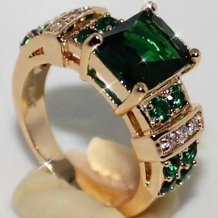 Gold ring with green crystal