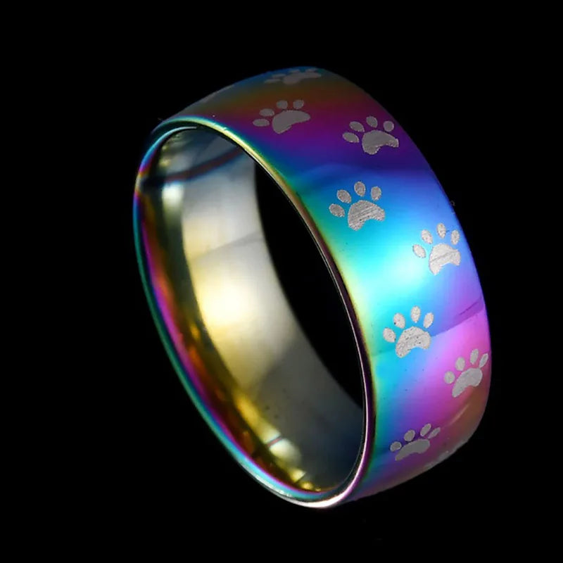 Handmade stainless steel ring in rainbow colours with a paw print.