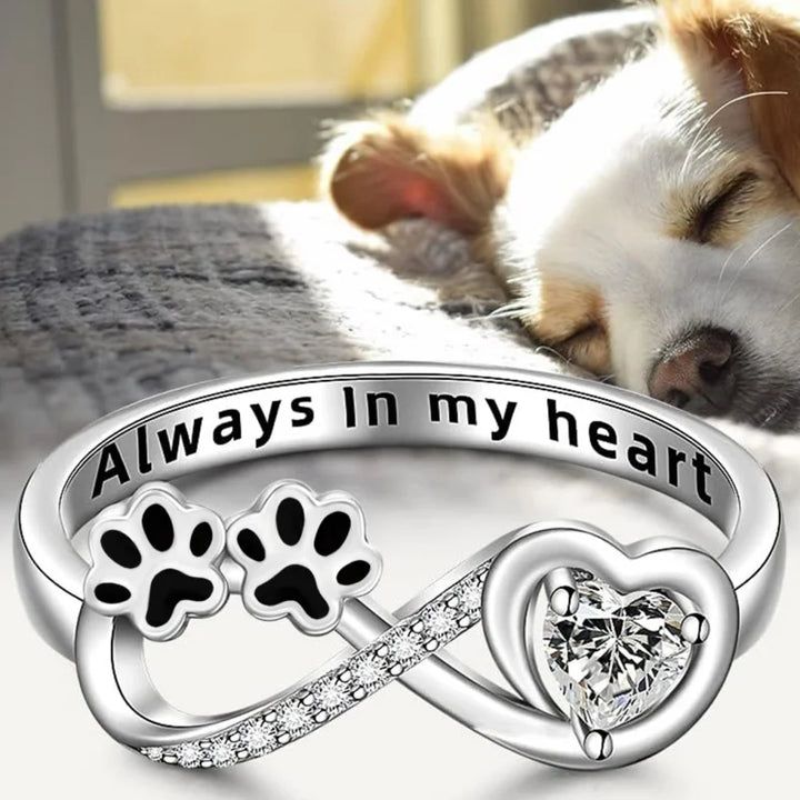 Ring with an open heart and an infinity symbol.