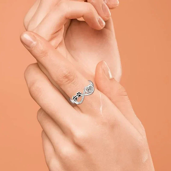 Ring with an open heart and an infinity symbol.
