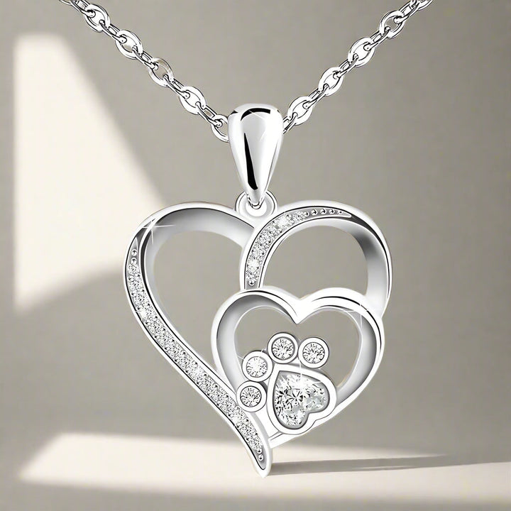 Silver necklace with a footprint and heart, set with zirconia.